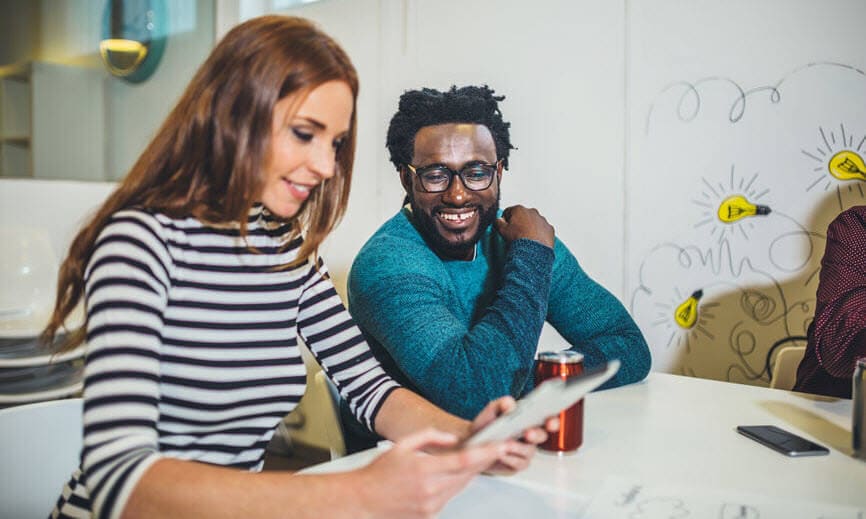 Man and woman working on a tablet together