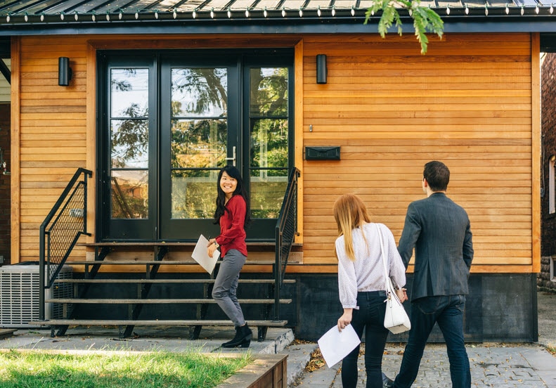 Realtor showing a house to a young couple