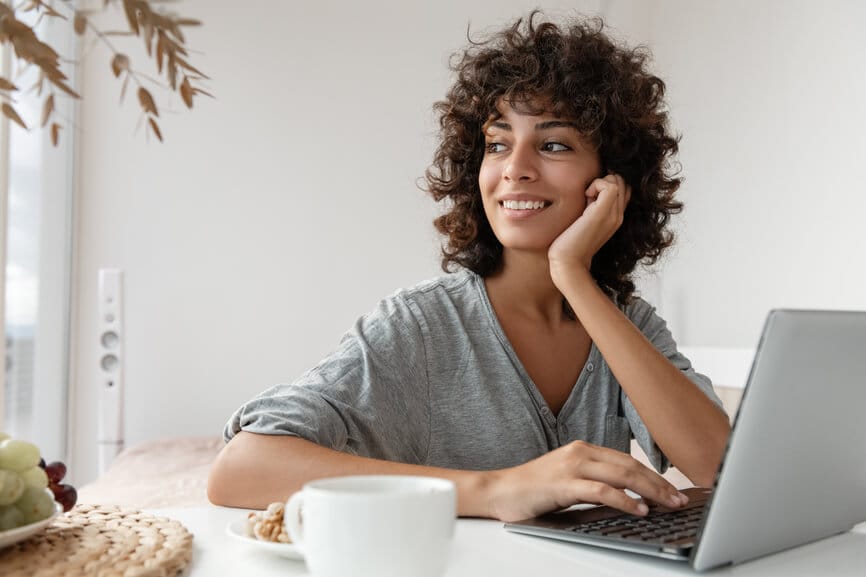 Smiling woman working on her laptop.