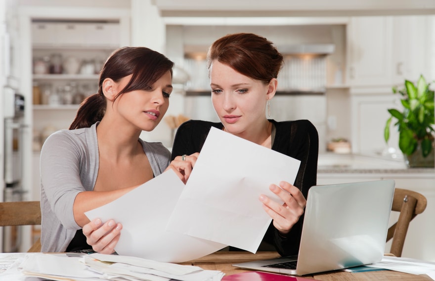 Two women overlooking paperwork