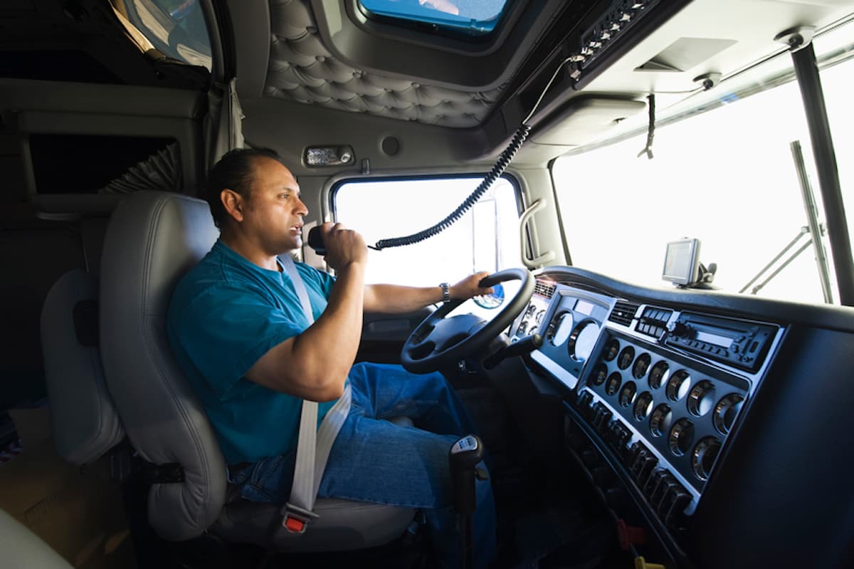 A truck driver speaks into his CB radio as he drives.