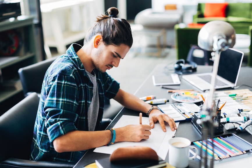 Young Illustrator Working In A Creative Office.