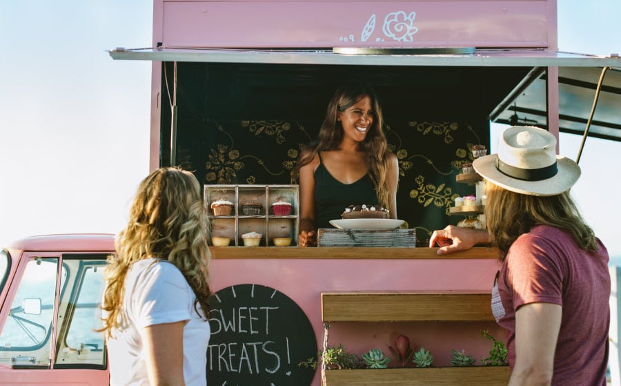 Woman selling cupcakes from a food truck