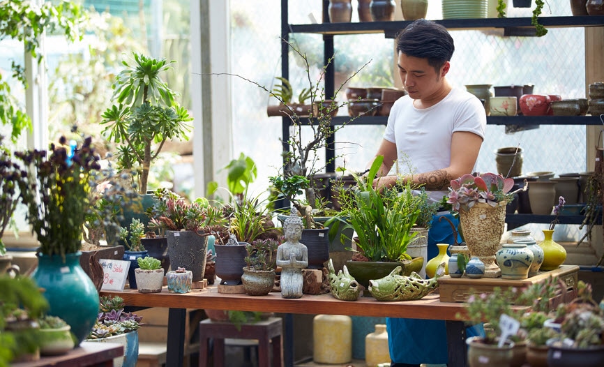 Young male florist busy at his shop