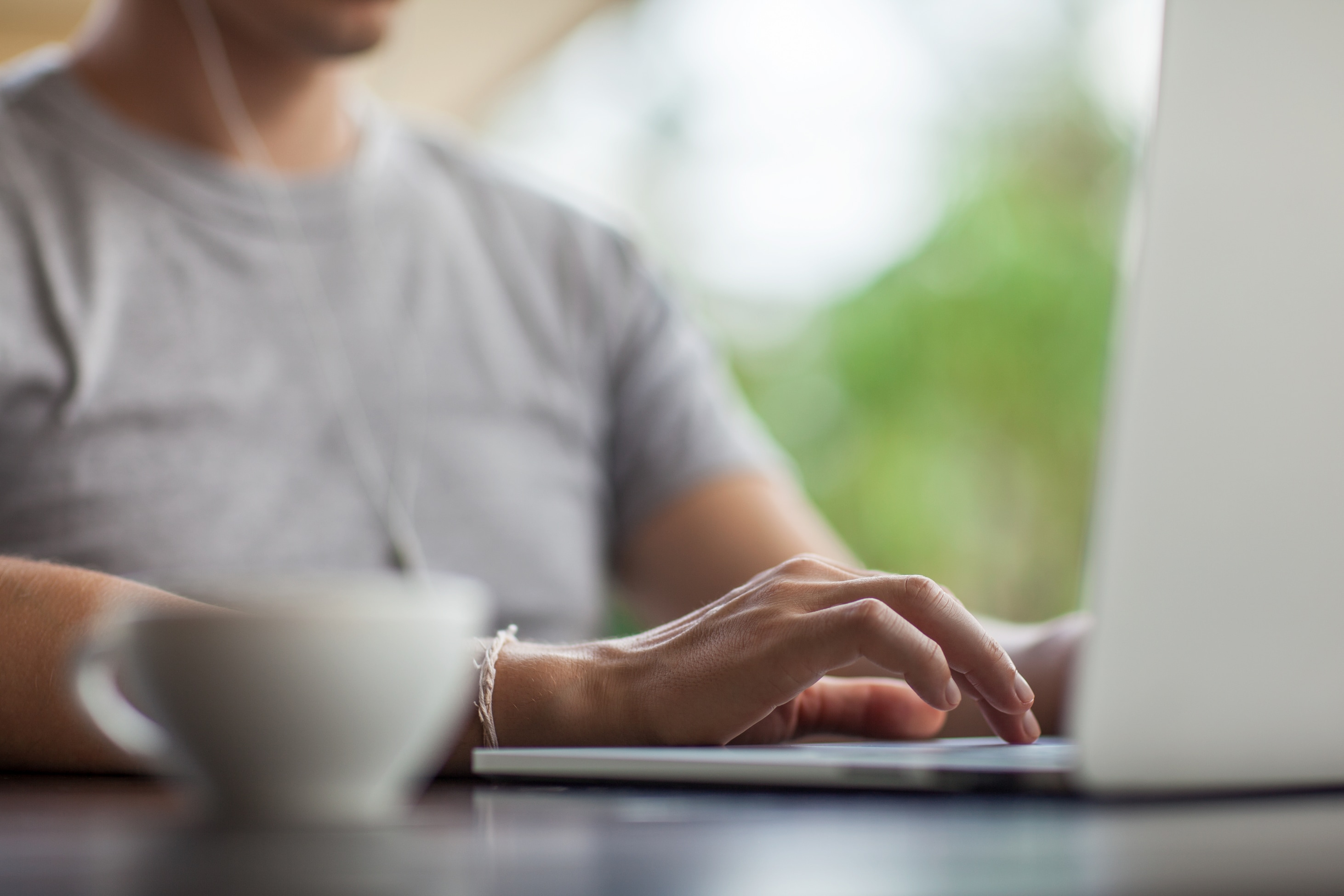 Cup of coffee next to computer