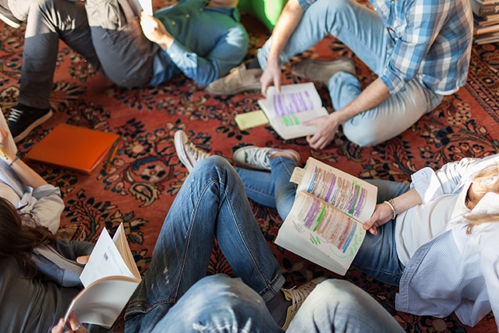 Kids reading a books on the ground