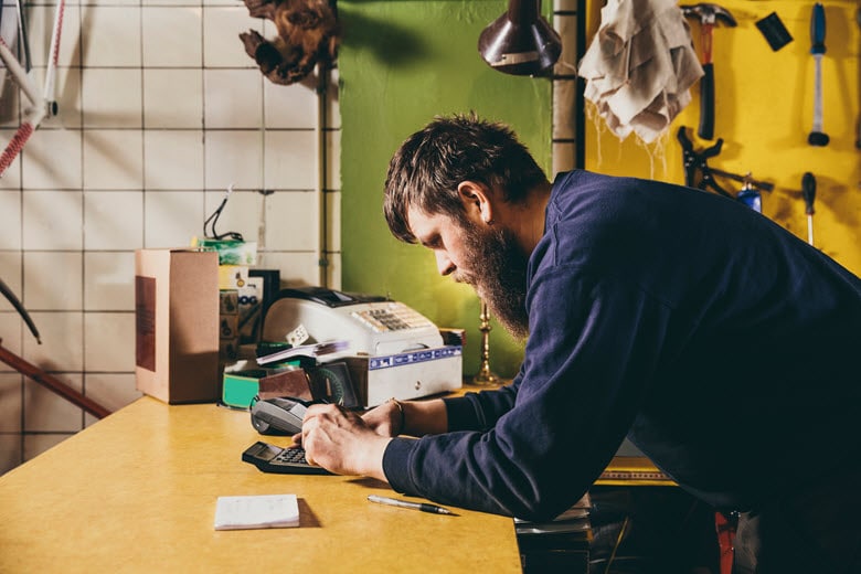 Man using a handheld calculator