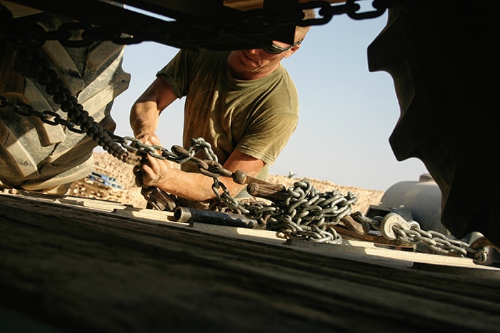 Military veteran strapping down truck