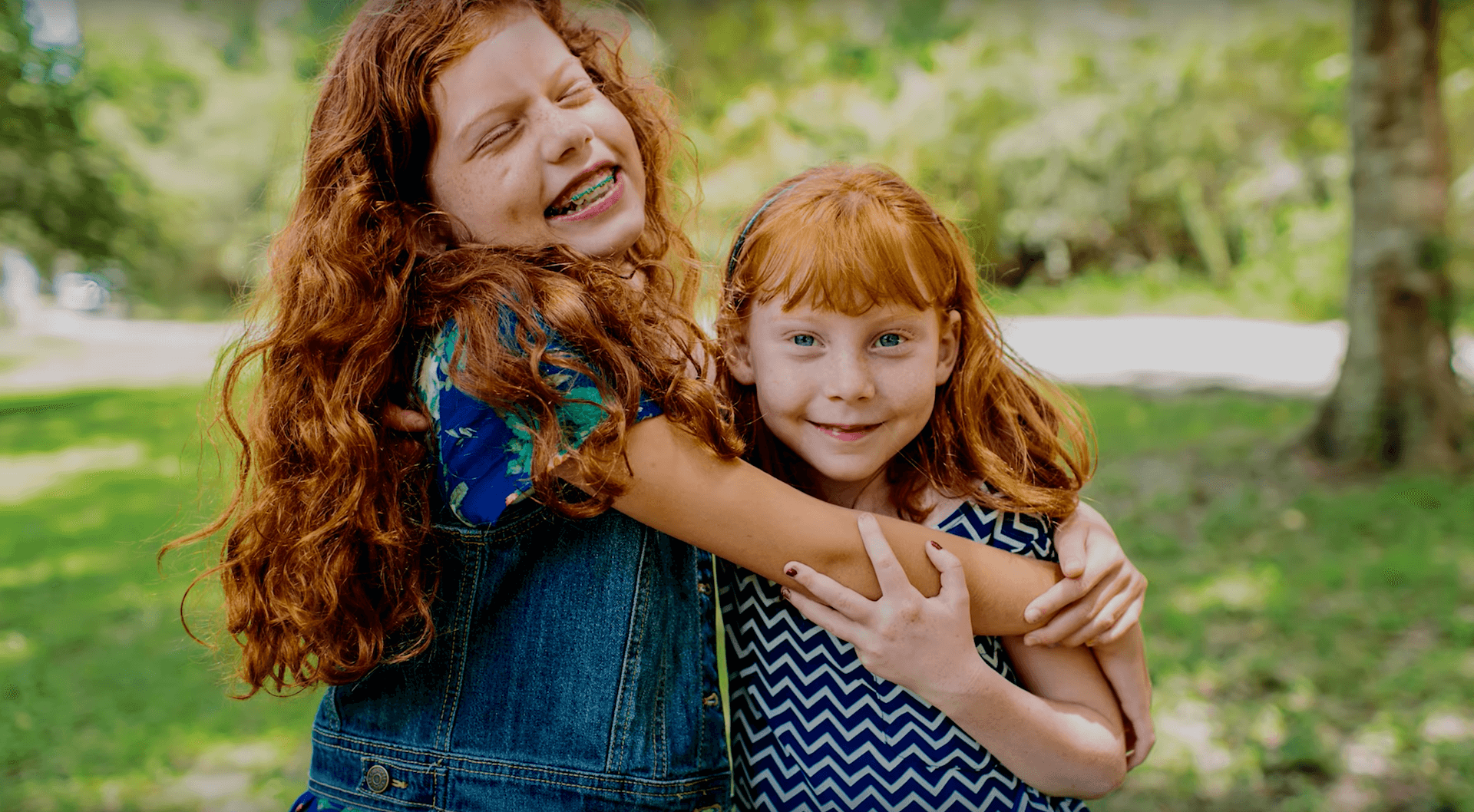 two smiling children hugging each other