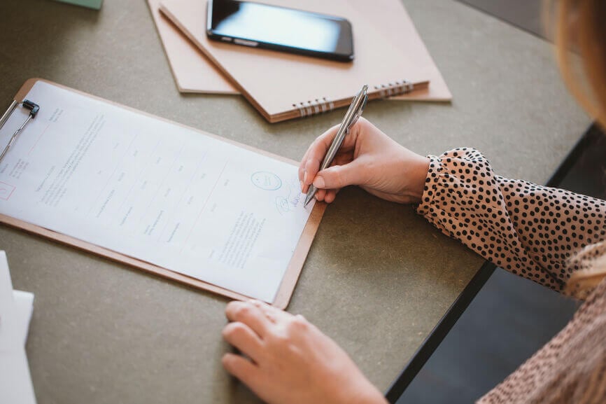 woman signing a document