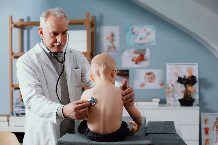 doctor checking a child's heartbeat