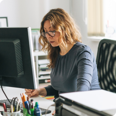 A person sitting at a desk with a laptop.