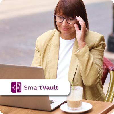 A person sitting at a table with a laptop.