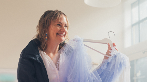 image of a woman holding a phone in a retail store