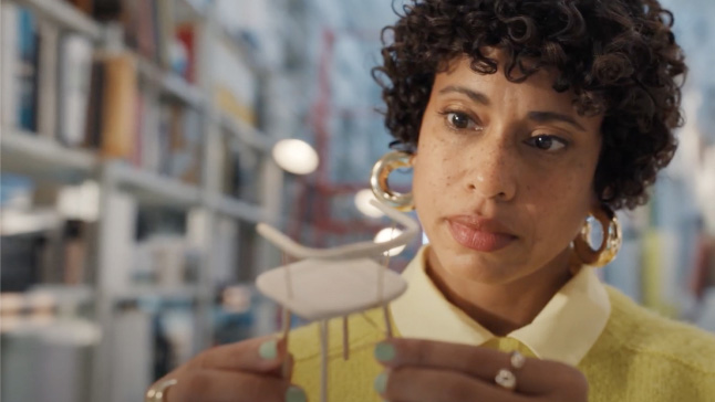 A person holding a toothbrush in her mouth.