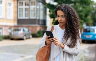 Woman walking with phone in hand