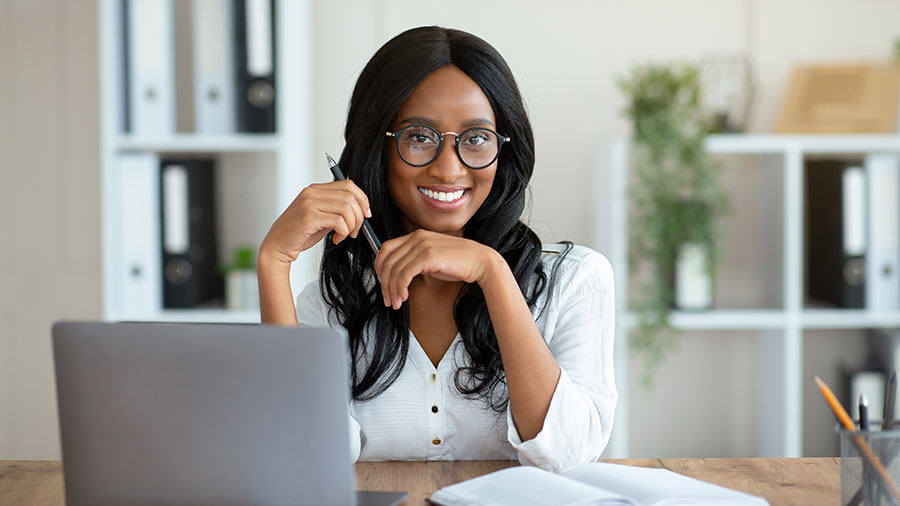 A person sitting at a desk with a laptop.