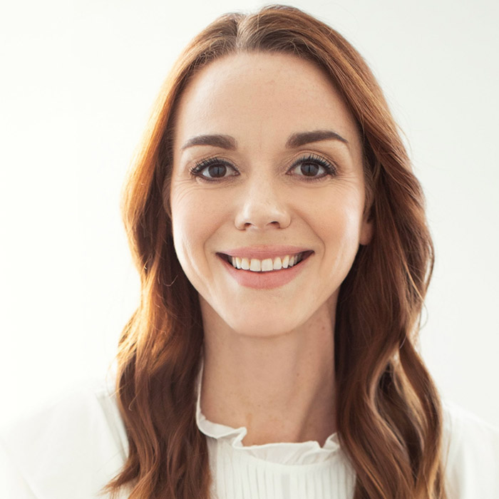 A person wearing a white shirt and a black tie.