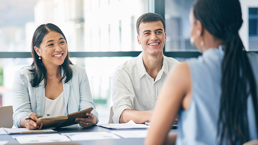 Two people interviewing a candidate for a job