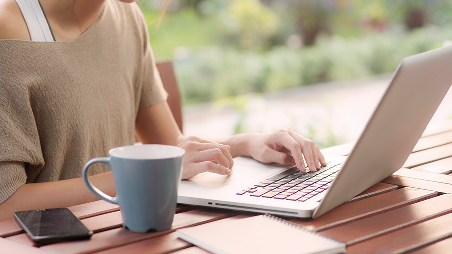 A person is typing on a laptop computer.