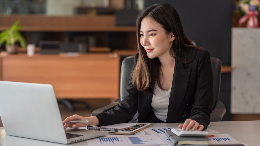 A person sitting at a desk with a laptop.