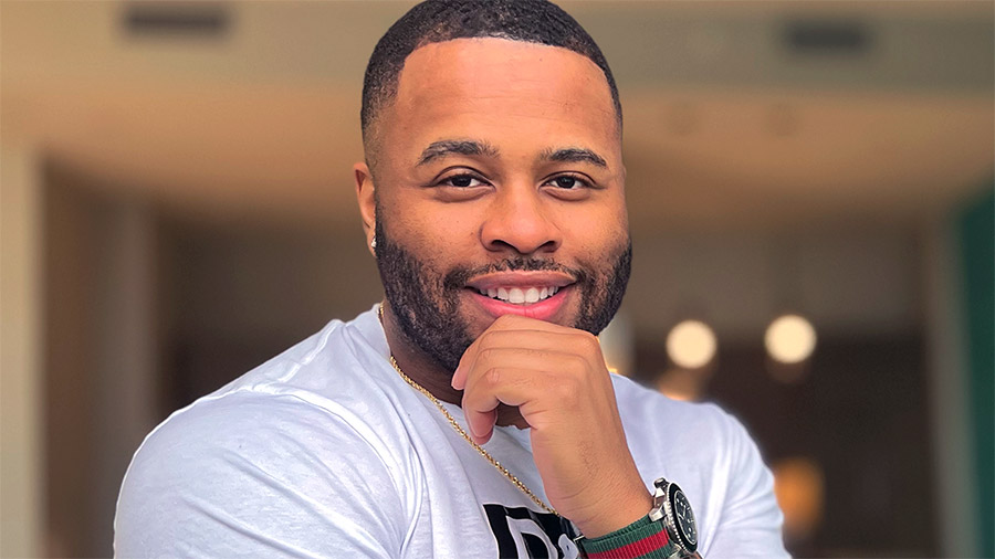 A person sitting on a bench smiling for the camera.