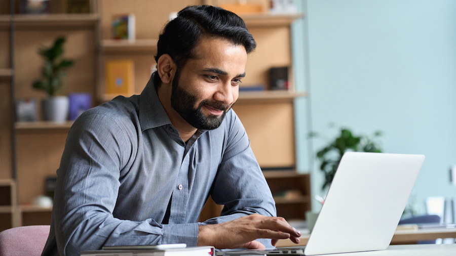 Accountant using QuickBooks Desktop on his laptop.