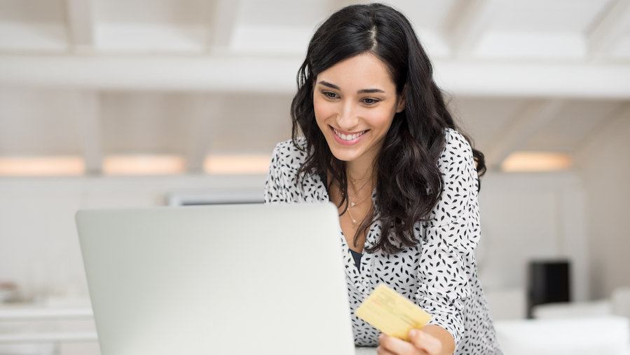 Woman reviewing bill pay for QuickBooks Online.