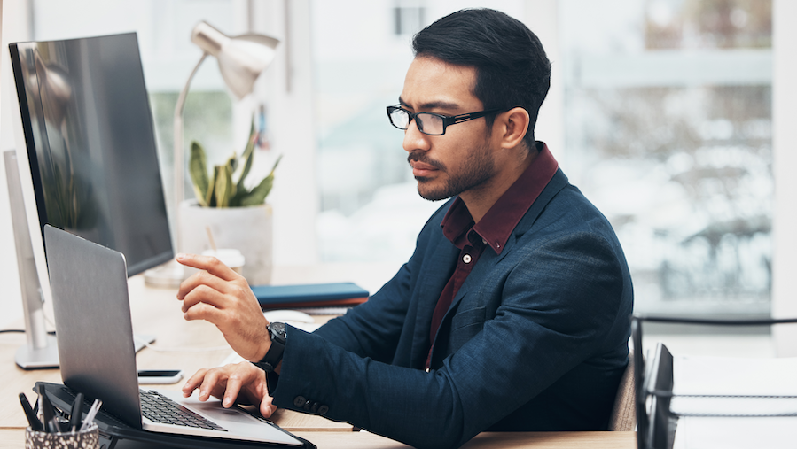 Businessman looking over changes in QuickBooks Desktop Payroll.