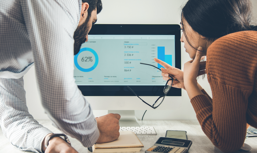 Two bookkeepers reviewing QuickBooks Online data.