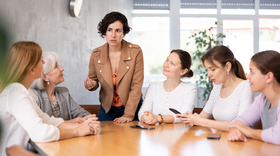 A group of women discussing business strategy.