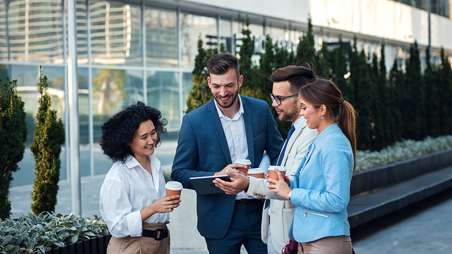 A group of people standing around a table.