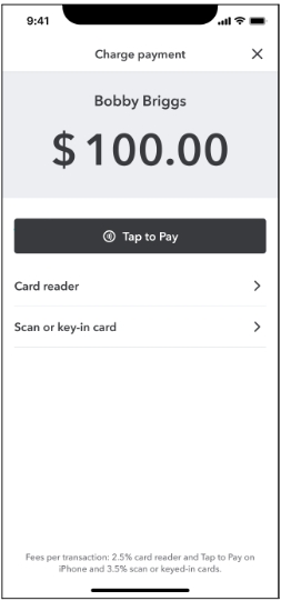 A person is typing on a phone next to a price sign.