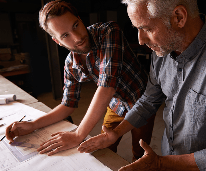 A person sitting on a couch using a laptop computer.
