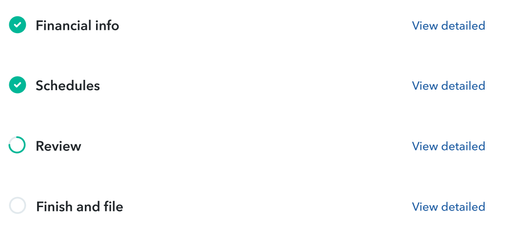 man on a laptop holding notes