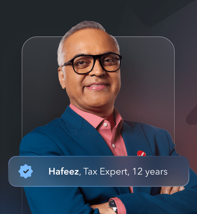 A middle-aged male TurboTax expert wearing a blue blazer and a red TurboTax pin.