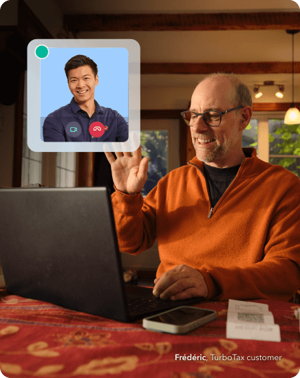 Man working on a laptop connecting with a TurboTax expert via video call for personalized tax help.