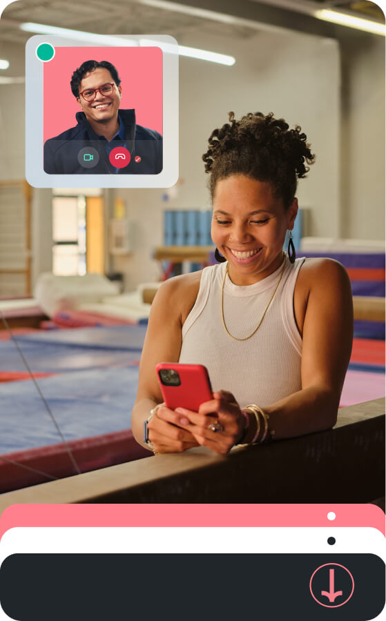 A smiling small business owner in a gymnastics studio uses her smartphone to consult with a TurboTax expert via a live video call overlay.