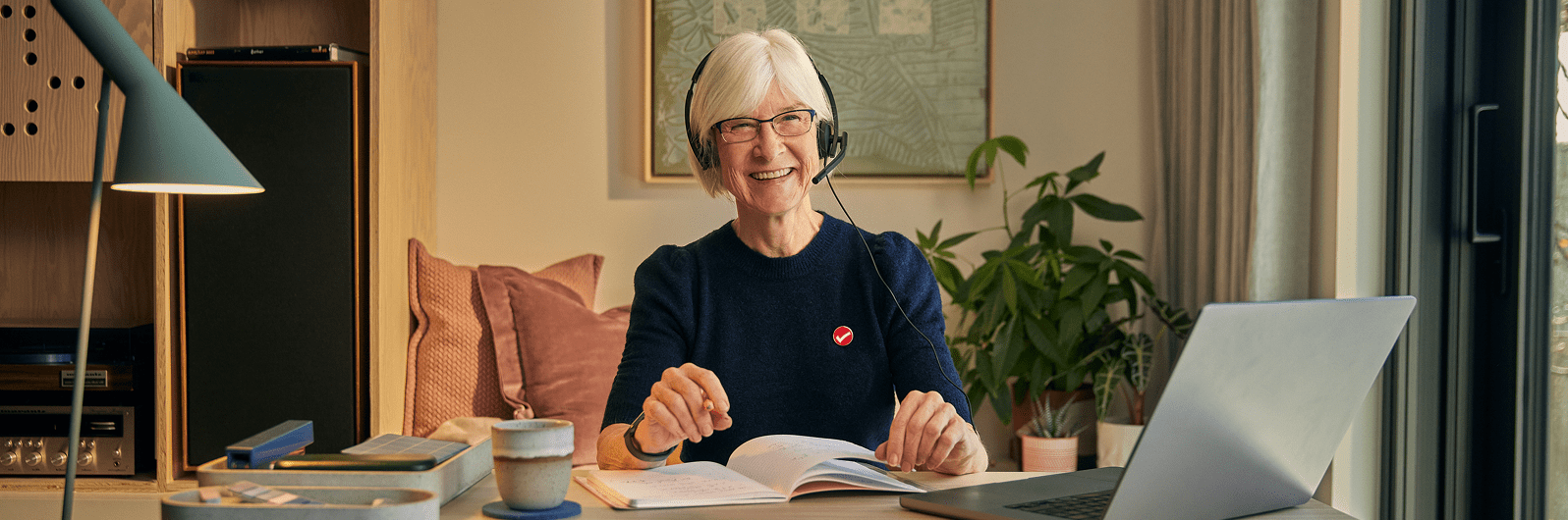 Marla, a TurboTax expert, smiling warmly in her home office.