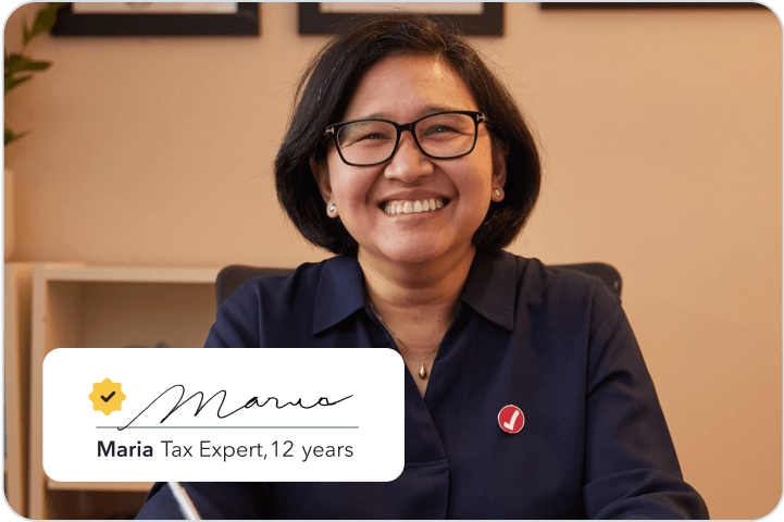 Maria, a TurboTax tax expert with 12 years of experience smiling brightly in her home office.