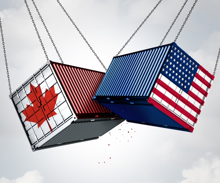 A person sitting on a couch using a laptop computer.