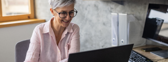 woman smiling at her computer screen