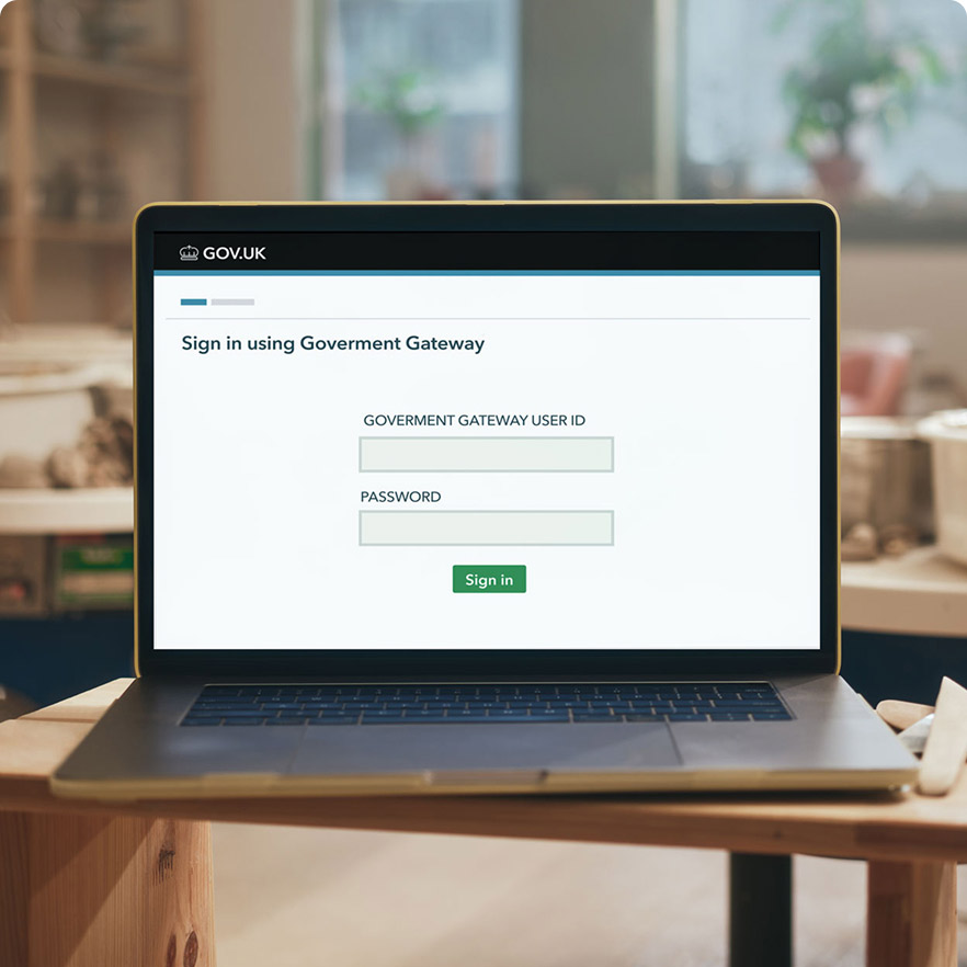 A laptop computer sitting on top of a wooden table.